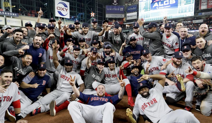 The Boston Red Sox pose for a picture after winning the baseball American League Championship Series against the Houston Astros on Thursday, Oct. 18, 2018, in Houston. Red Sox won 4-1. (AP Photo/David J. Phillip)