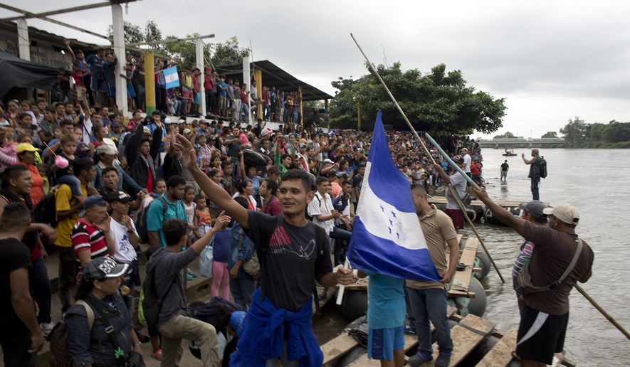 Hundreds of Honduran migrants stand at the shore of the Suchiate river on the border between Guatemala and Mexico, in Tecun Uman, Guatemala, Thursday, Oct. 18, 2018. Mexico&#39;s foreign ministry says government officials at its southern border with Guatemala have started assisting the early arrivals from a caravan of some 3,000 Honduran migrants that has drawn sharp criticism from U.S. President Donald Trump. (AP Photo)