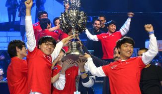 FILE - In this Oct. 4, 2013, file photo, members of Korea&#39;s SK Telecom T1 team celebrate with their trophy after defeating China&#39;s Royal Club at the League of Legends Season 3 World Championship Final, in Los Angeles. Die-hard esports fans are gathering by the thousands in South Korea this month to watch the world’s top League of Legends players show off their skill and expertise.In the United States, the game’s publisher is hoping to draw a more casual crowd by starting with an important question: What is League of Legends? (AP Photo/Mark J. Terrill,File)