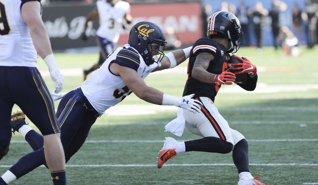 Oregon State wide receiver Trevon Bradford slips a tackle from California's Jordan Kunaszyk during the first half of an NCAA college football game in Corvallis, Ore., Saturday, Oct. 20, 2018. (AP Photo/Amanda Loman)