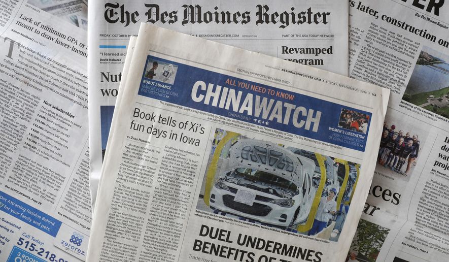 This Friday, Oct. 19, 2018, photo shows a copy of the four-page advertising section Chinawatch along with a copy of The Des Moines Register in Des Moines, Iowa. China&#39;s propaganda machine has taken aim at American soybean farmers as part of its high-stakes trade war with the Trump administration. The publication last month of the four-page advertising section in the Register opened a new battle line in China&#39;s effort to break the administration&#39;s resolve. (AP Photo/Charlie Neibergall)