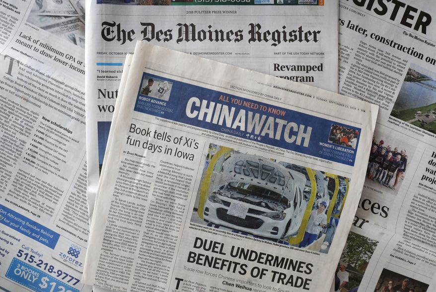 This Friday, Oct. 19, 2018, photo shows a copy of the four-page advertising section Chinawatch along with a copy of The Des Moines Register in Des Moines, Iowa. China&#39;s propaganda machine has taken aim at American soybean farmers as part of its high-stakes trade war with the Trump administration. The publication last month of the four-page advertising section in the Register opened a new battle line in China&#39;s effort to break the administration&#39;s resolve. (AP Photo/Charlie Neibergall)