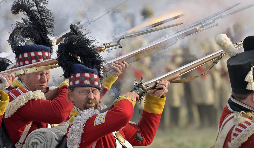 Troops fight during the reconstruction of the Battle of the Nations at the 205th anniversary near Leipzig, Germany, Saturday, Oct. 20, 2018. The Battle of Leipzig or Battle of the Nations, on 16–19 October 1813, was fought by the coalition armies of Russia, Prussia, Austria and Sweden against the French army of Napoleon. The battle decided that Napoleon had to retreat to France, the beginning of his downfall. (AP Photo/Jens Meyer)