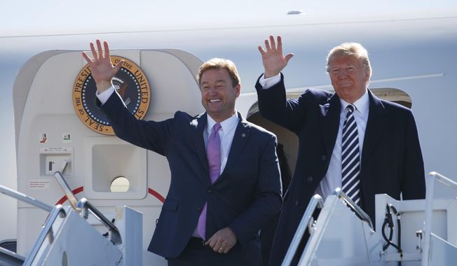 President Donald Trump arrives with Sen. Dean Heller, R-Nev., on Air Force One at Elko Regional Airport, Saturday, Oct. 20, 2018, in Elko, Nv., for a campaign rally. (AP Photo/Carolyn Kaster)