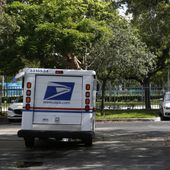 A mail carrier for the United States Postal Service drives away after delivering mail to an apartment complex on Thursday, June 14, 2018, in Aventura, Fla. (AP Photo/Brynn Anderson)
