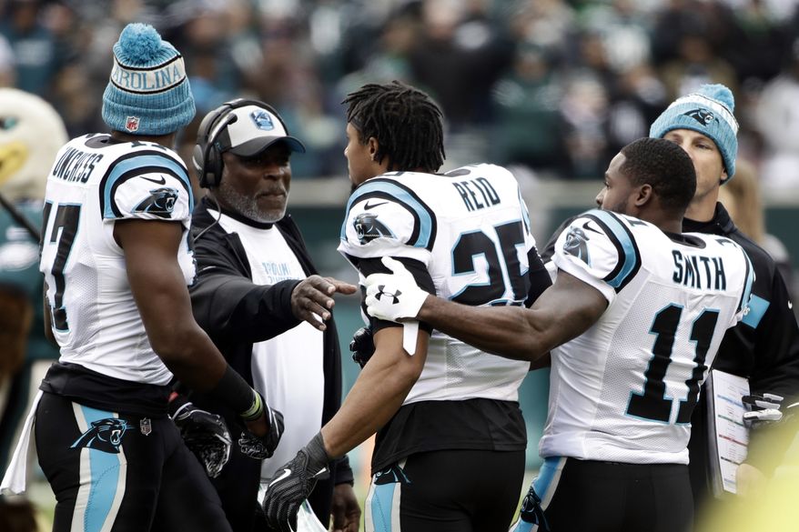 Carolina Panthers strong safety Eric Reid (25) is held back by wide receiver Torrey Smith (11) during an argument prior to an NFL football game against the Philadelphia Eagles, Sunday, Oct. 21, 2018, in Philadelphia. (AP Photo/Matt Rourke)