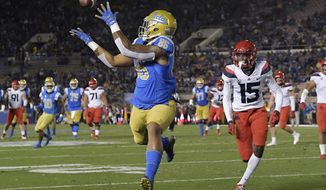UCLA tight end Devin Asiasi, left, makes a touchdown catch as Arizona cornerback McKenzie Barnes watches during the first half of an NCAA college football game, Saturday, Oct. 20, 2018, in Pasadena, Calif. (AP Photo/Mark J. Terrill)