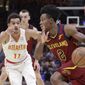 Cleveland Cavaliers&#39; Collin Sexton (2) drives past Atlanta Hawks&#39; Trae Young (11) in the first half of an NBA basketball game, Sunday, Oct. 21, 2018, in Cleveland. (AP Photo/Tony Dejak)