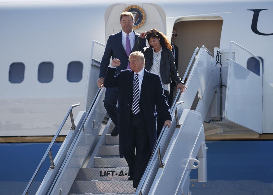 President Donald Trump arrives with Sen. Dean Heller, R-Nev., and his wife Lynne Heller on Air Force One at Elko Regional Airport, Saturday, Oct. 20, 2018, in Elko, Nev., for a campaign rally. (AP Photo/Carolyn Kaster)