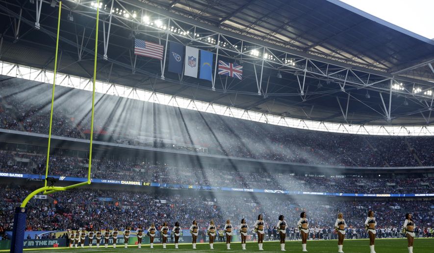 Cheerleaders line up before an NFL football game between Tennessee Titans and Los Angeles Chargers at Wembley stadium in London, Sunday, Oct. 21, 2018. (AP Photo/Matt Dunham)
