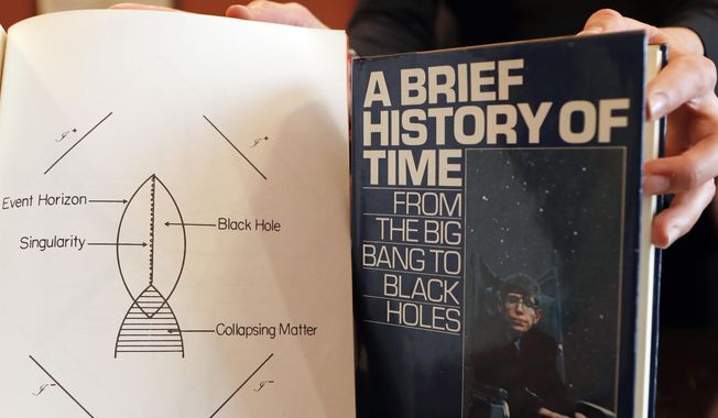 A book and scripts are among the personal and academic possessions of Stephen Hawking at the auction house Christies in London, Friday, Oct. 19, 2018. (AP Photo/Frank Augstein) ** FILE **