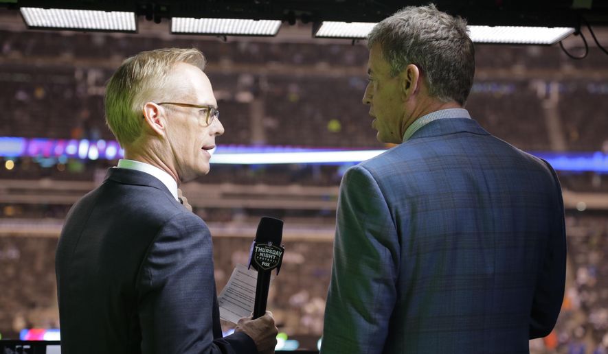 Troy Aikman, right, and Joe Buck work before an NFL football game between the New York Giants and the Philadelphia Eagles on Thursday, Oct. 11, 2018, in East Rutherford, N.J. With the Fall Classic going the full seven games the past two seasons, Joe Buck is preparing for Boston and Los Angeles to go the distance as well. The World Series also comes in the midst of the busiest month of Buck’s 25-year career at Fox. He normally does only baseball once the League Championship Series begin, but he has added Thursday Night Football to his schedule. (AP Photo/Frank Franklin II)