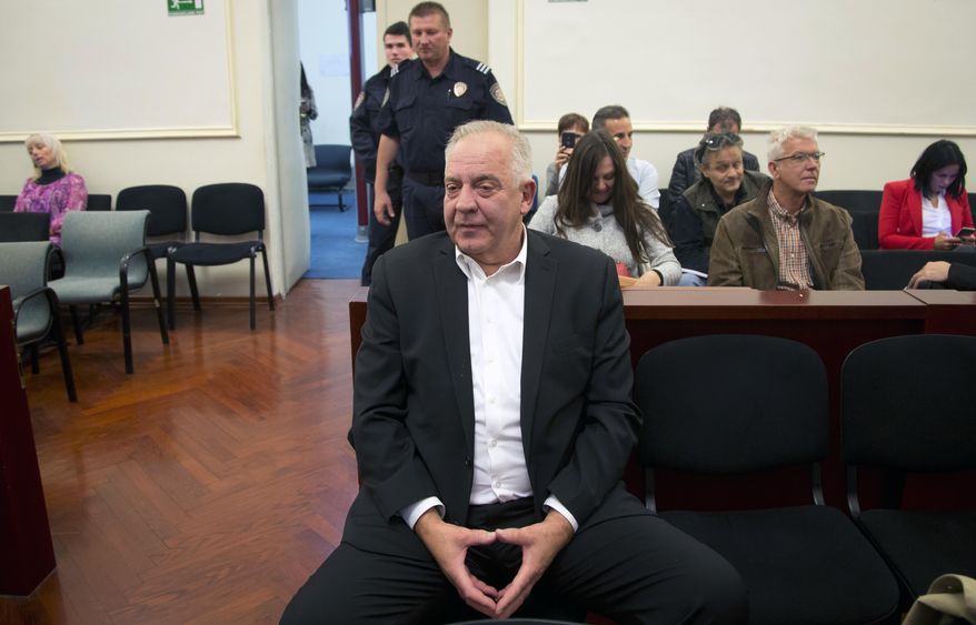 Croatia's former prime minister Ivo Sanader sits in the courtroom prior to the reading of his verdict, in Zagreb, Croatia, Monday, Oct. 22, 2018. Sanader was sentenced Monday for two and a half years in prison for war profiteering. (AP Photo/Darko Bandic)