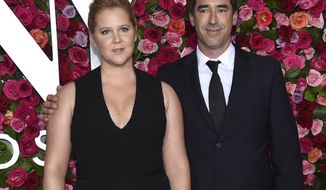FILE - In this June 10, 2018 file photo, Amy Schumer, left, and Chris Fischer arrive at the 72nd annual Tony Awards in New York.  Schumer announced she’s pregnant with husband Fischer. She broke her baby news Monday on the Instagram stories of friend and journalist Jessica Yellin. (Photo by Evan Agostini/Invision/AP, File)