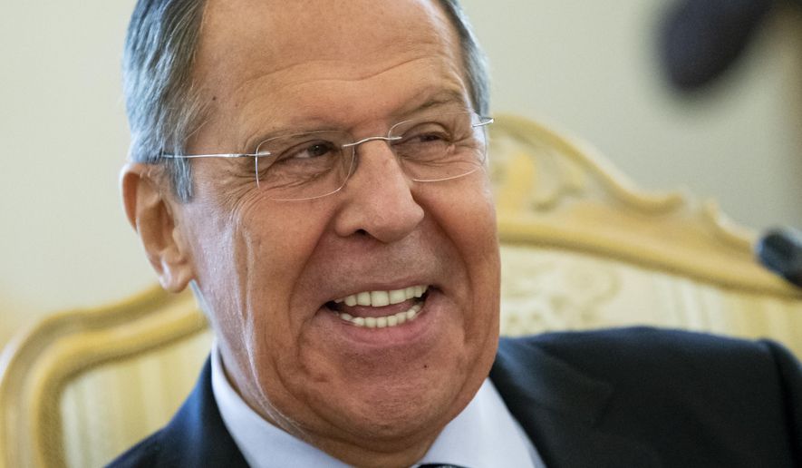 Russian Foreign Minister Sergey Lavrov smiles as he speaks to Madagascar&#39;s Foreign Minister Eloi Maxime Alphonse Dovo during their meeting in Moscow, Russia, Monday, Oct. 22, 2018. Lavrov will meet with U.S. National Security Adviser John Bolton for high-tension talks in Moscow, after President Donald Trump announced his intention to withdraw from a landmark nuclear weapons treaty. (AP Photo/Alexander Zemlianichenko)