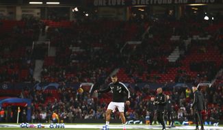 Juventus forward Cristiano Ronaldo kicks a ball during warmup before the Champions League group H soccer match between Manchester United and Juventus at Old Trafford, Manchester, England, Tuesday, Oct. 23, 2018. (AP Photo/Dave Thompson)
