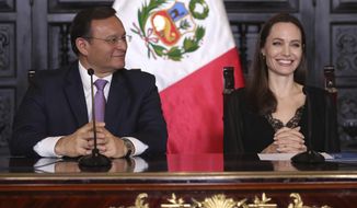 Hollywood actress Angelina Jolie and Peru&#39;s Foreign Minister Nestor Popolizio hold a joint press conference at government palace in Lima, Peru, Tuesday, Oct. 23, 2018.  Jolie, who met with Venezuelans refugees on Monday, is in Peru as a special envoy for the UN&#39;s High Commissioner for Refugees. (AP Photo/Martin Mejia)