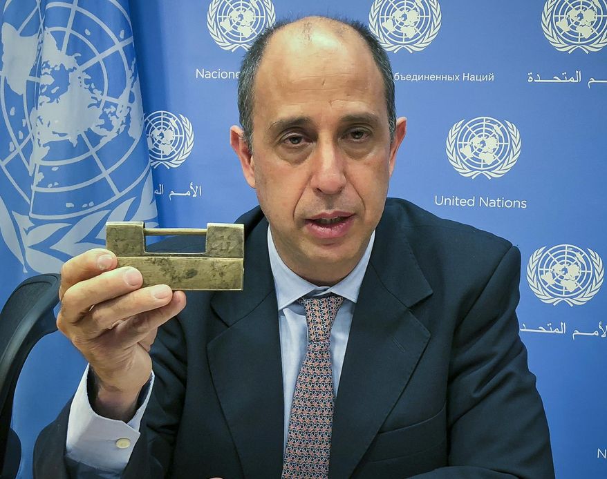 Tomas Ojea Quintana, the United Nations special investigator on human rights in North Korea, holds up a lock given to him by North Koreans who escaped from the country, during a press conference, Tuesday Oct. 23, 2018, at U.N. headquarters in New York. Quintana said the escapees told him: "You have the key to open the lock," and that he was "very concerned" that human rights were not mentioned in the statements after the summits between the leaders of North Korea and South Korea or between North Korean leader Kim Jong Un and U.S. President Donald Trump. (AP Photo/Edith M. Lederer)