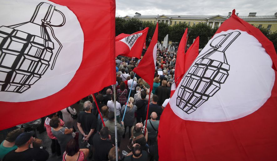 People gather for the Communist Party rally protesting retirement age hikes in St.Petersburg, Russia, Sunday, Sept. 2, 2018. Several thousand people gathered in central Moscow and St.Petersburg on Sunday for a protest organized by the Communist Party and other demonstrations were reported in Vladivostok in the Far East and Barnaul and Novosibirsk in Siberia. (AP Photo/Dmitri Lovetsky)