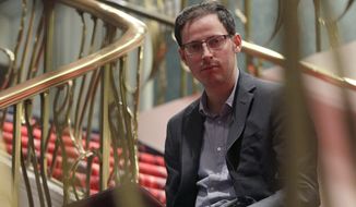 Nate Silver sits on the stairs at Allegro hotel in downtown Chicago, Friday, Nov. 9, 2012. The 34-year-old statistician, unabashed numbers geek, author and creator of the much-read FiveThirtyEight blog at The New York Times, correctly predicted the presidential winner in all 50 states, and almost all the Senate races. (AP Photo/Nam Y. Huh)