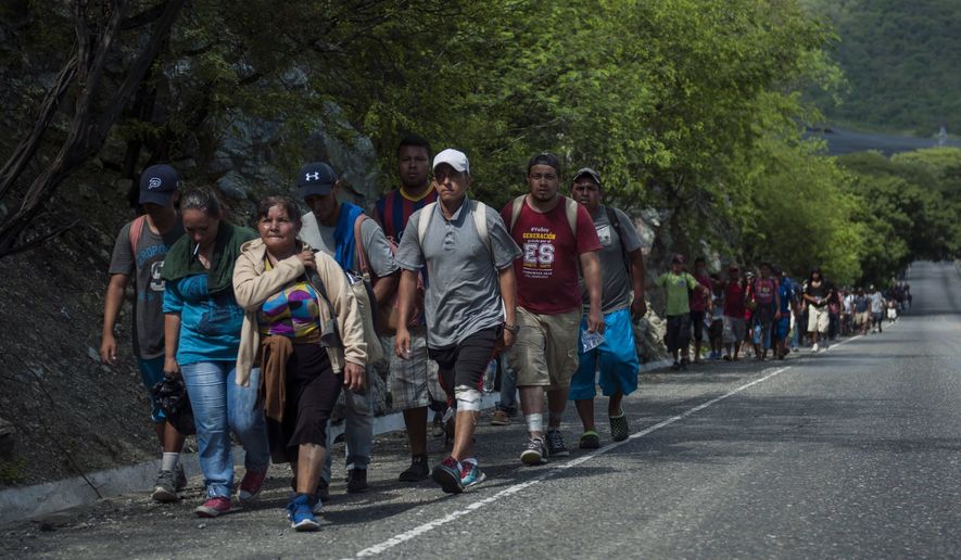 Honduras migrants walk to the U.S as they approach Zacapa, about 70 miles northeast of Guatemala City, Wednesday, Oct. 24, 2018. This new group of a few hundred Honduran migrants are behind the first group that has swelled to thousands and is currently traveling through Mexico. (AP Photo/Oliver de Ros)