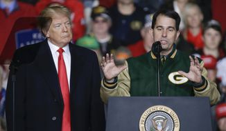 With President Donald Trump at his side, Wisconsin Gov. Scott Walker speaks during a rally Wednesday, Oct. 24, 2018, in Mosinee, Wis. (AP Photo/Mike Roemer) **FILE**