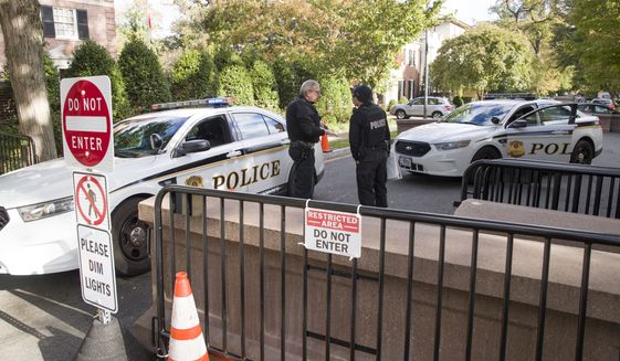Officers with the Uniform Division of the United States Secret Service talk at a checkpoint near the home of President Barack Obama, Wednesday, Oct. 24, 2018, in Washington. The U.S. Secret Service says agents have intercepted packages containing &quot;possible explosive devices&quot; addressed to former President Barack Obama and Hillary Clinton. (AP Photo/Alex Brandon)