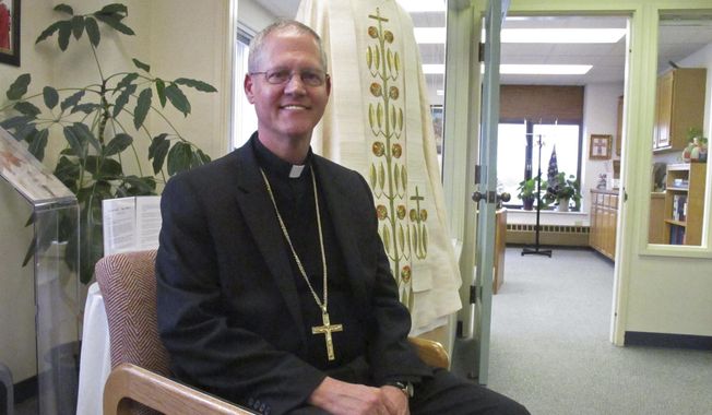 Catholic Archbishop Paul Etienne is shown Wednesday, Oct. 24, 2018, at his office in Anchorage, Alaska. Etienne said the Anchorage Archdiocese has ordered an independent review of sexual abuse claims by reviewing the files of priests and others associated with the archdiocese since it was established in 1966. (AP Photo/Rachel D'Oro)