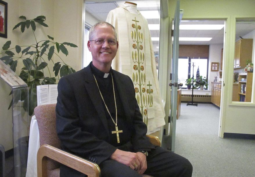 Catholic Archbishop Paul Etienne is shown Wednesday, Oct. 24, 2018, at his office in Anchorage, Alaska. Etienne said the Anchorage Archdiocese has ordered an independent review of sexual abuse claims by reviewing the files of priests and others associated with the archdiocese since it was established in 1966. (AP Photo/Rachel D'Oro)