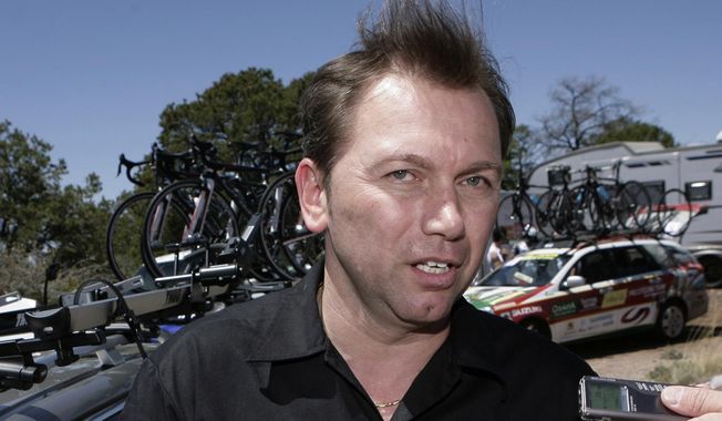 FILE - In this April 29, 2009, file photo, Astana cycling team general manager Johan Bruyneel answers questions from the media after the first stage of the Tour of the Gila cycling race in Mogollon, N.M. In a letter posted on social media Wednesday, Oct. 24, 2018, Bruyneel, Lance Armstrong’s former team manager, said he’s been given a lifetime ban from cycling for his role in a doping program that helped Armstrong win the Tour de France seven times. (AP Photo/Jake Schoellkopf, File)