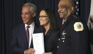 FILE - In this Sept. 13, 2918, file photo, Illinois Attorney General Lisa Madigan, center, Chicago police Superintendent Eddie Johnson, right, and Mayor Rahm Emanuel hold up a copy of the proposed consent decree during a news conference in Chicago. A federal judge who will decide whether to approve a lengthy court-oversight plan to reform the Chicago Police Department started a highly anticipated two-day hearing Wednesday, Oct. 24, 2018, by saying he would allow dozens of people to voice their opinions on the proposal. The plan hammered out by city officials and the Illinois Attorney General&#39;s Office has widespread support in minority neighborhoods that have long been suspicious of police and complained about police misconduct. (Antonio Perez /Chicago Tribune via AP, File)