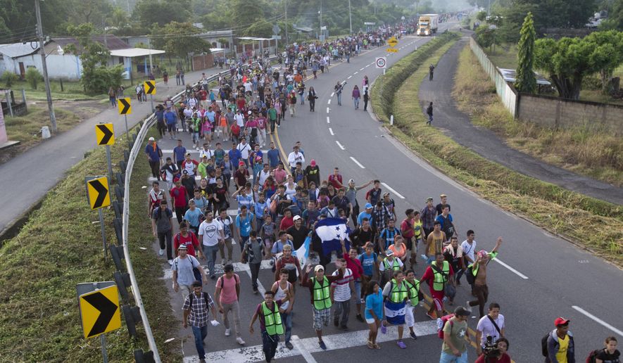 In this Oct. 21, 2018, photo, Central American migrants walking to the U.S. start their day departing Ciudad Hidalgo, Mexico. (AP Photo/Moises Castillo)