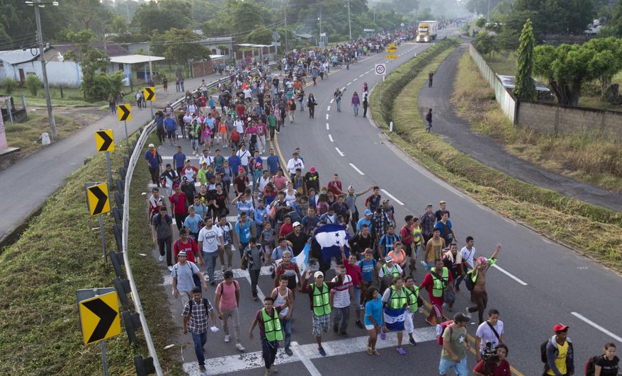 In this Oct. 21, 2018, photo, Central American migrants walking to the U.S. start their day departing Ciudad Hidalgo, Mexico. (AP Photo/Moises Castillo)