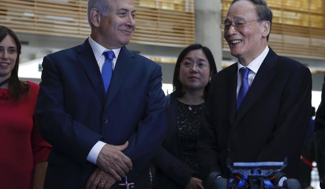 China&#x27;s Vice President Wang Qishan, right, and Israeli Prime Minister Benjamin Netanyahu tour the Israeli Innovation Summit in Jerusalem, Wednesday, Oct. 24, 2018. (AP Photo/Ariel Schalit, Pool)