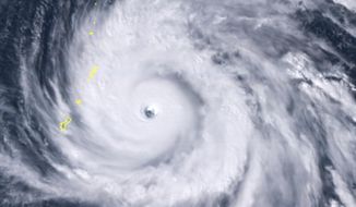 This satellite image provided by the National Oceanic and Atmospheric Administration (NOAA) shows Typhoon Yutu east of Guam Wednesday afternoon, Oct. 24, 2018 local time. The storm crossed over the U.S. Commonwealth of the Northern Mariana Islands, producing damaging winds and high surf. The National Weather Service in Honolulu says maximum sustained winds of 180 mph (290 kph) were recorded around the eye of the storm, which passed over Tinian island and Saipan early Thursday morning local time. Waves of 25 to 40 feet (6 to 12 meters) are expected around the eye of the storm. (NOAA via AP)