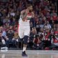 Washington Wizards forward Markieff Morris, right, gestures in front of Portland Trail Blazers guard CJ McCollum after making a 3-point basket during the second half of an NBA basketball game in Portland, Ore., Monday, Oct. 22, 2018. (AP Photo/Craig Mitchelldyer) **FILE**