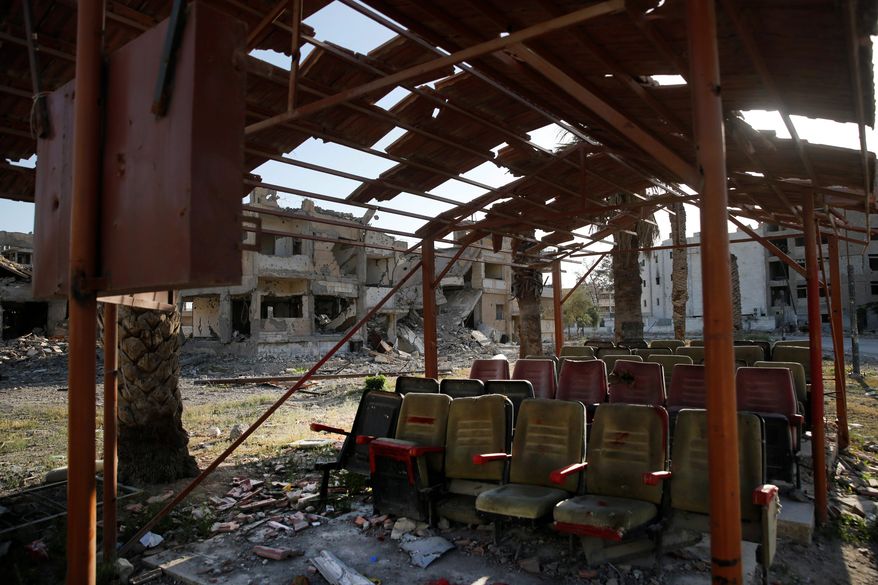 This Thursday, April 5, 2018, file photo, shows a media center the Islamic State group used to screen propaganda videos, which was destroyed last summer during fighting between U.S.-backed Syrian Democratic Forces fighters and Islamic State militants, in Raqqa, Syria. Six months after IS was driven out, residents of Raqqa feel they have been abandoned as the world moves on. They are trying to rebuild but fear everyone around them: the Kurdish-led militia that administers the majority Arab city; Syrian government forces nearby; gangs who kidnap or rob whoever shows signs of having money; and IS militants who may still be hiding among the people. (AP Photo/Hussein Malla)