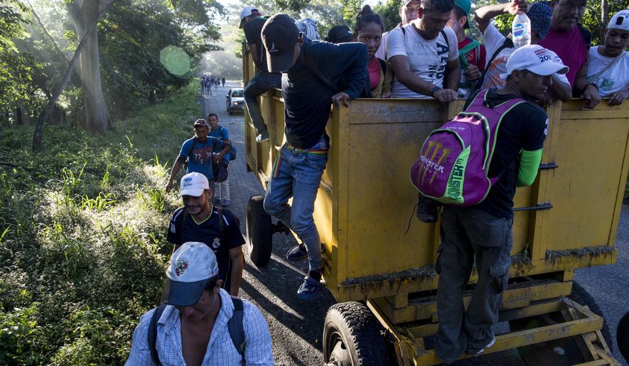 Central American migrants traveling with a caravan to the U.S. make their way to Pijijiapan, Mexico, Thursday, Oct. 25, 2018. The sprawling caravan of migrants hoping to make their way to the United States set off again, forming a column more than a mile long as the group trekked out of the town of Mapastepec in southern Mexico before dawn. (AP Photo/Rodrigo Abd)