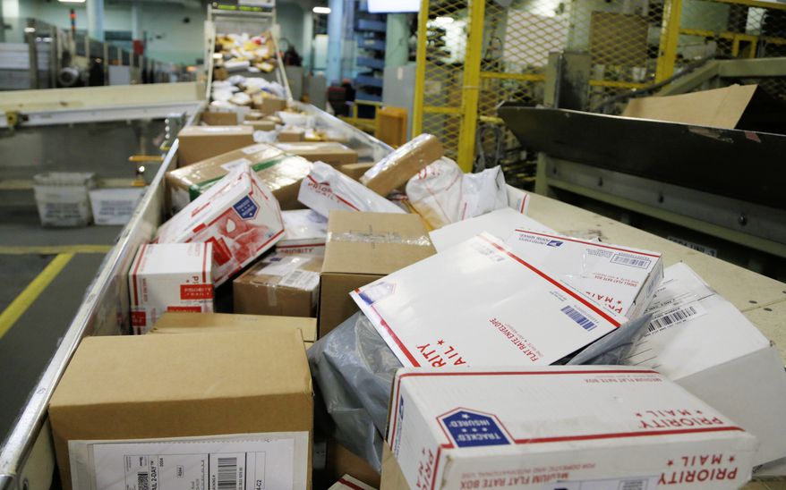 FILE - In this Dec. 14, 2018 file photo, packages travel on a conveyor belt for sorting at the main post office in Omaha, Neb. The shipment of several pipe bombs to CNN and several prominent Democrats raises fresh questions about mail safety and what measures the U.S. Postal Service and private delivery services take to prevent explosives and other illegal substances from entering into the mail. (AP Photo/Nati Harnik, File)