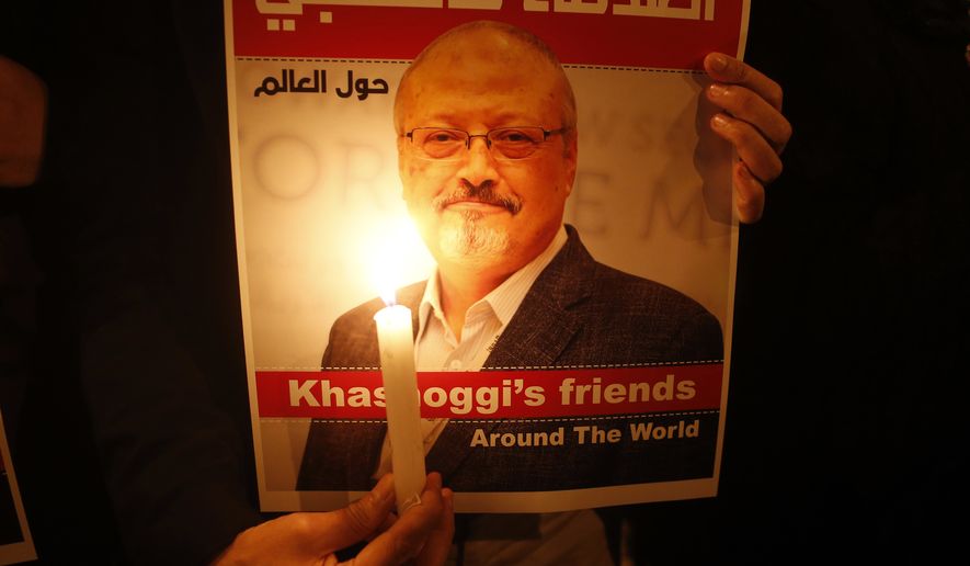 Activists, protesting the killing of Saudi journalist Jamal Khashoggi, hold a candlelight vigil outside Saudi Arabia&#39;s consulate in Istanbul, Thursday, Oct. 25, 2018. The poster reads in Arabic:&#39; Khashoggi&#39;s Friends Around the World&#39;. A group of Arab and international public, political and media figures are establishing a global association called &quot;Khashoggi&#39;s Friends Around the World&quot;; &quot;to achieve justice for the freedom martyr&quot;.(AP Photo/Lefteris Pitarakis)