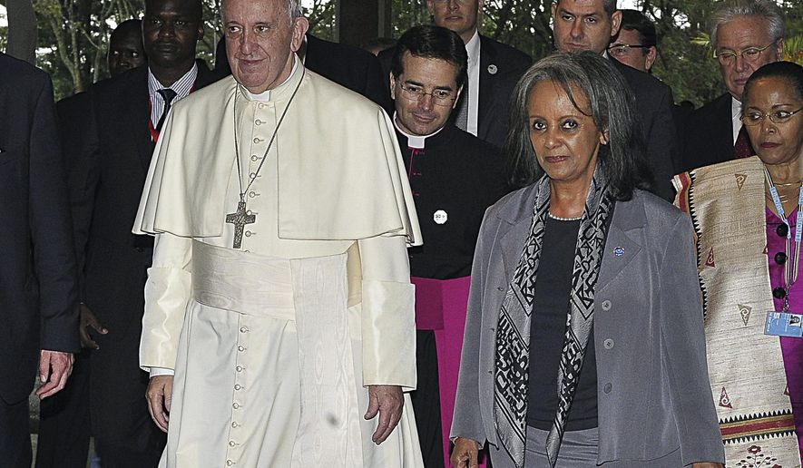 FILE - In this Thursday, Nov. 26, 2015 file photo, Pope Francis walks next to then Director-General of the United Nations Office at Nairobi (UNON) Sahle-Work Zewde, right, upon his arrival there in Nairobi, Kenya. Ethiopian lawmakers unanimously elected the seasoned diplomat Sahle-Work Zewde as the country's first female president, a largely ceremonial post, on Thursday, Oct. 25, 2018. (Simon Maina/Pool via AP, File)