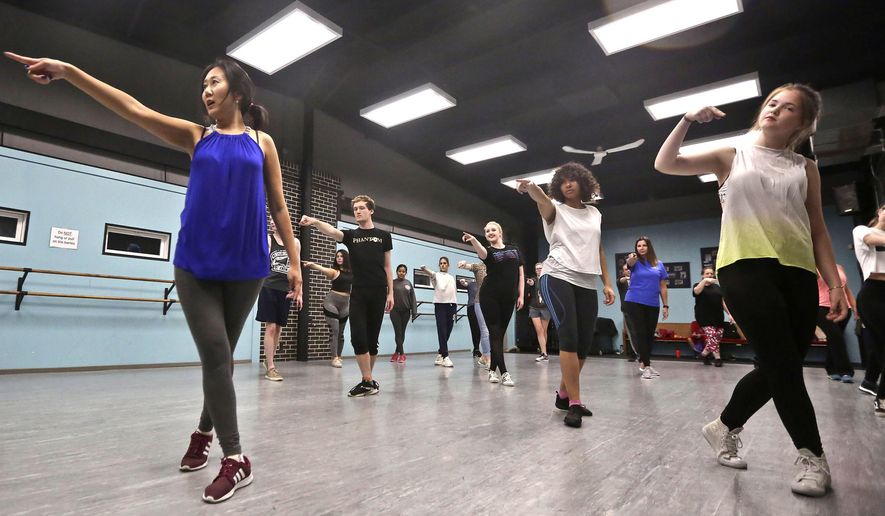 In this Sept. 27, 2018 photo, Hye Lim Cho, right, teaches hip/hop dance class at the Poage Arts  and Recreation Center in Decatur, Ill. The popular Korean music scene, K-pop, has made its way to Decatur, and local dance students have the opportunity to learn from a professional K-pop instructor. Cho, who is a Decatur attorney, began teaching her country&#x27;s modern style of dance to students at the Decatur Park District&#x27;s Poage Arts and Recreation Center about a year ago. (Clay Jackson/Herald &amp;amp; Review via AP)