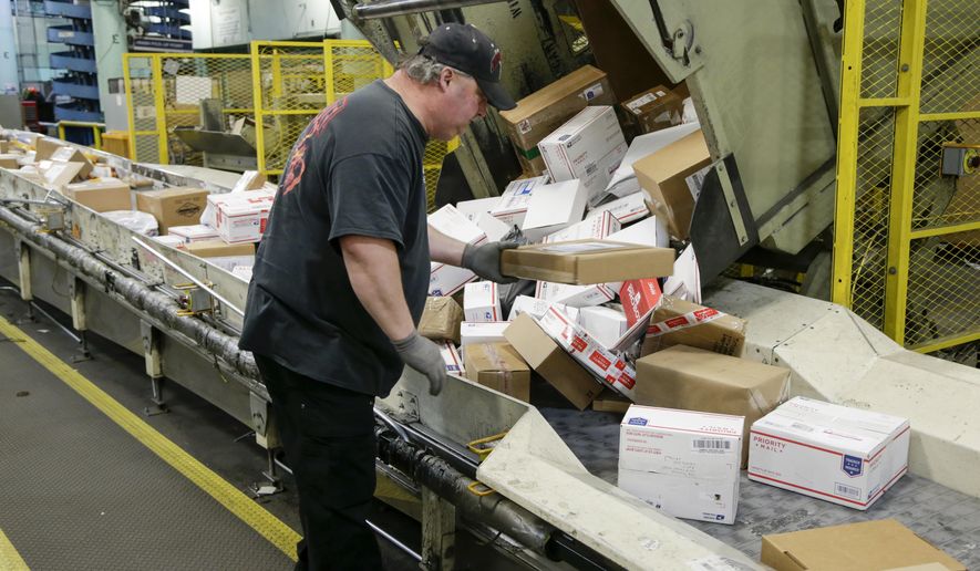 FILE - In this Dec. 14, 2017 file photo, Steve Robino arranges packages on a conveyor belt at the main post office in Omaha, Neb. The shipment of several pipe bombs to CNN and several prominent Democrats raises fresh questions about mail safety and what measures the U.S. Postal Service and private delivery services take to prevent explosives and other illegal substances from entering into the mail. (AP Photo/Nati Harnik, File)