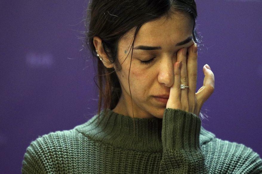 Nadia Murad, a Yazidi who escaped the Islamic State and a co-recipient of this year's Nobel Peace Prize, reacts while speaking during a news conference at the International Federation for Human Rights office in Paris, Thursday, Oct. 25, 2018. An international human rights group says foreign fighters, including many Europeans, were responsible for carrying out the Islamic State group's atrocities against minority Yazidis. (AP Photo/Francois Mori)