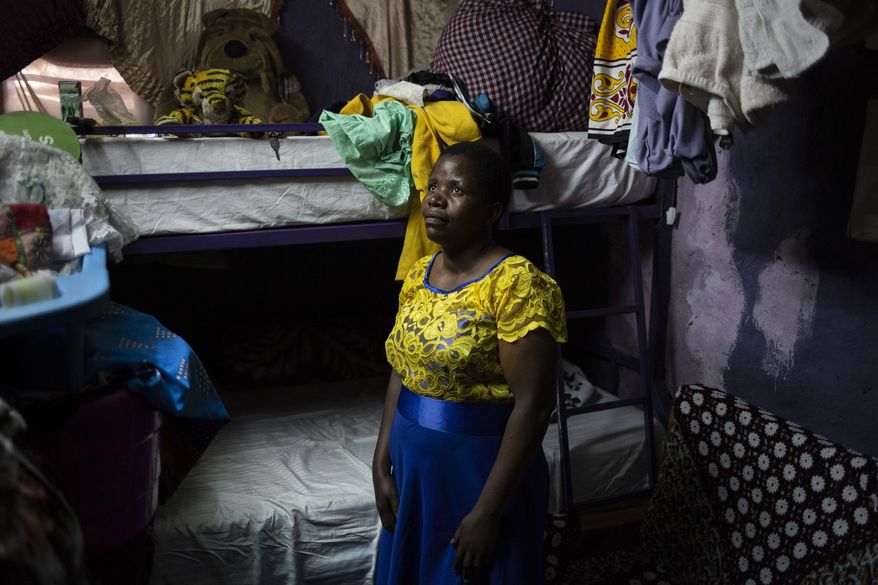 Margaret Oliele, former detained patient, poses for a portrait in her home in Nairobi, Kenya. During a botched cesarean section in 2010, doctors left a pair of surgical scissors inside her stomach; a second surgery was needed to remove the scissors and she later suffered a ruptured bladder and a blood infection. When she couldn’t pay her hospital fees, Oliele was taken to a detention ward. “I tried to escape, but when I got to the main gate, I was taken by the security guards.” (AP Photo/Bram Janssen)