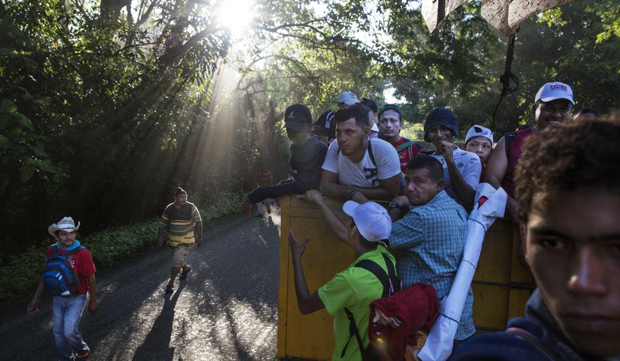 Central American migrants traveling with a caravan to the U.S. make their way to Pijijiapan, Mexico, Thursday, Oct. 25, 2018. There are a relatively tiny number of Nicaraguans who decided to try their luck with the caravan of thousands of Central Americans, mostly Hondurans, currently making its way through southern Mexico. (AP Photo/Rodrigo Abd)