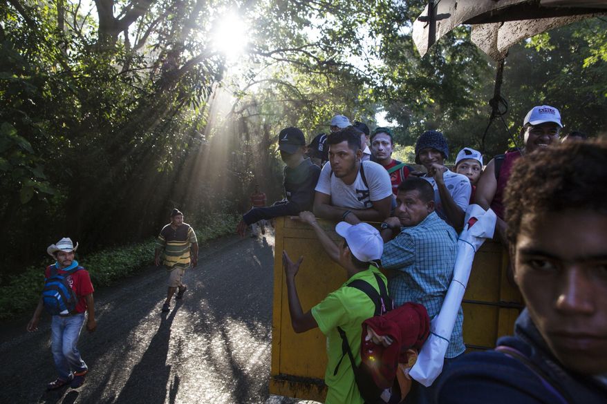 Central American migrants traveling with a caravan to the U.S. make their way to Pijijiapan, Mexico, Thursday, Oct. 25, 2018. There are a relatively tiny number of Nicaraguans who decided to try their luck with the caravan of thousands of Central Americans, mostly Hondurans, currently making its way through southern Mexico. (AP Photo/Rodrigo Abd)
