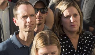 Matt and Jill McCluskey, parents of Lauren McCluskey attend a vigil for their daughter on Wednesday. Oct 24, 2018 in Salt Lake City.  Police said Melvin Rowland fatally shot McCluskey of Pullman, Washington, on Monday night on the university campus and then killed himself in a church as officers closed in.  (Jeremy Harmon/The Salt Lake Tribune via AP)