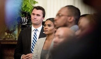 Conservative commentator and conservative advocacy group Turning Point USA Director of Communications Candace Owens, center, listens as President Donald Trump speaks at the 2018 Young Black Leadership Summit in the East Room of the White House, Friday, Oct. 26, 2018, in Washington. (AP Photo/Andrew Harnik) 