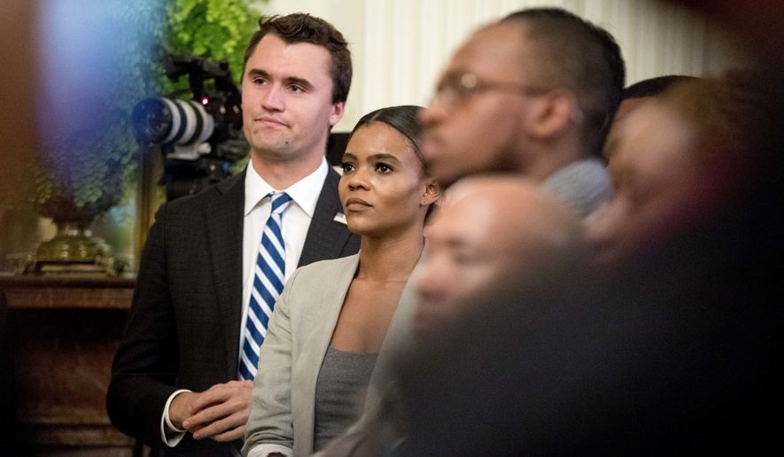 Conservative commentator and conservative advocacy group Turning Point USA Director of Communications Candace Owens, center, listens as President Donald Trump speaks at the 2018 Young Black Leadership Summit in the East Room of the White House, Friday, Oct. 26, 2018, in Washington. (AP Photo/Andrew Harnik)
